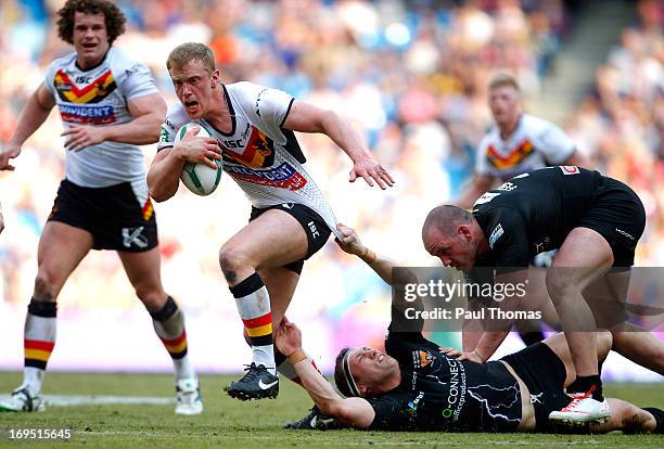 Tom Olbison of Bradford is tackled by Shaun Lunt of Huddersfield during the Super League Magic Weekend match between Bradford Bulls and Huddersfield...