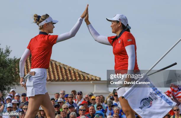 Nelly Korda of The United States team is congratulated by her partner Allisen Corpuz after holing a birdie putt to win the ninth hole in their match...