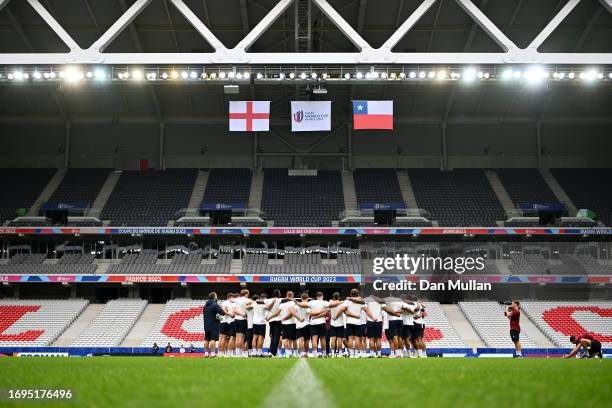 The England players huddle on the pitch during the Captain's Run ahead of their Rugby World Cup France 2023 match against Chile at Stade Pierre...