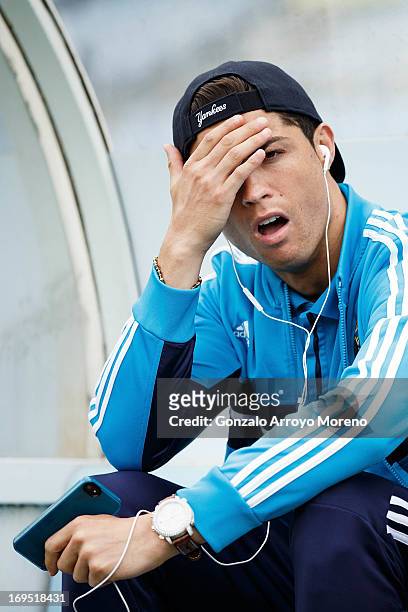 Cristiano Ronaldo of Real Madrid CF reacts annoyed while listen to music on his cell phone with headphones prior to start the La Liga match between...