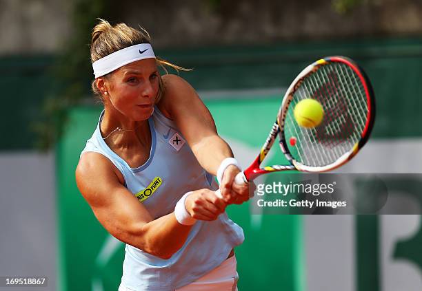 Mandy Minella of Luxembourg plays a backhand during her women's singles match against Dinah Pfizenmaier of Germany on day one of the French Open at...