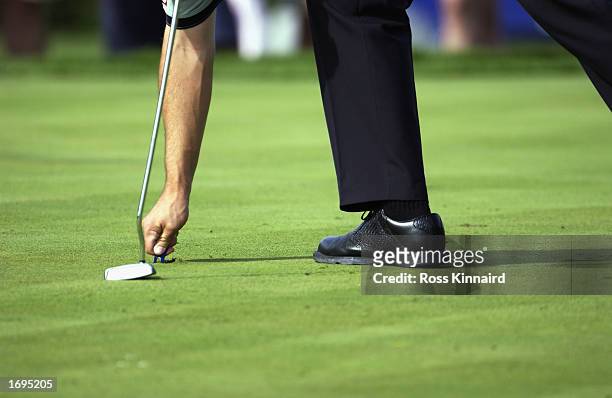 Padraig Harrington of Ireland repairs his pitch mark on the par three 3rd hole during the first round of the Volvo Masters at the Valderrama Golf...