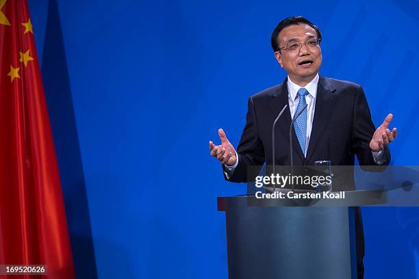 Chinese Prime Minister Li Keqiang gestures at a press conference with German Chancellor Angela Merkel at the Chancellery on May 26, 2013 in Berlin,...