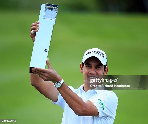 Matteo Manassero of Italy celebrates with the trophy on the eighteenth green after winning the fourth play-off hole during the final round of the BMW...