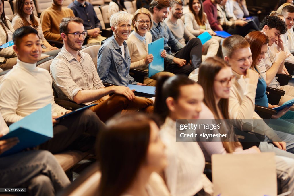 Crowd of people attending a seminar in convention center.