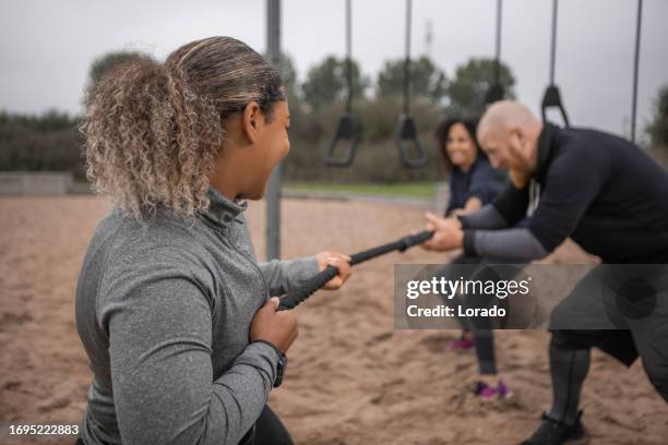 two beautiful diverse female friends exercising outdoors - built space stock pictures, royalty-free photos & images