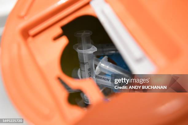 Used syringes are pictured in a sharps bin, inside the UK's first drug consumption room, where users can take their own illegal drugs under medical...