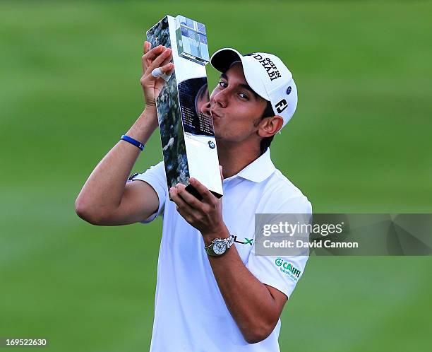 Matteo Manassero of Italy celebrates with the trophy on the eighteenth green after winning the fourth play-off hole during the final round of the BMW...