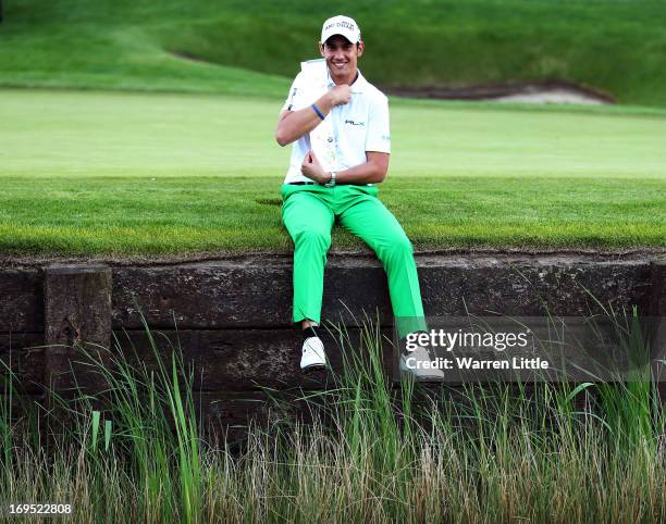 Matteo Manassero of Italy celebrates with the trophy on the eighteenth green after winning the fourth play-off hole during the final round of the BMW...