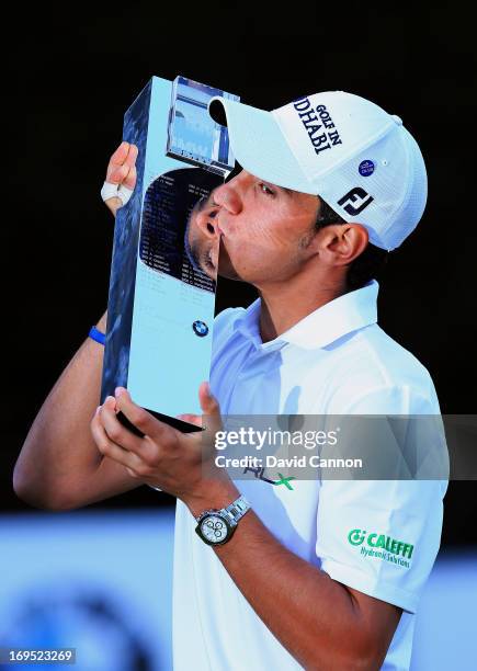 Matteo Manassero of Italy celebrates with the trophy on the eighteenth green after winning the fourth play-off hole during the final round of the BMW...