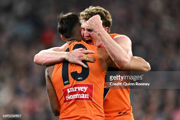 Tom Green of the Giants celebrates with Isaac Cumming of the Giants after kicking a goal during the AFL First Preliminary Final match between...