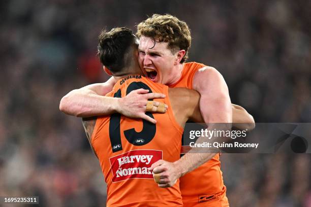 Tom Green of the Giants celebrates with Isaac Cumming of the Giants after kicking a goal during the AFL First Preliminary Final match between...