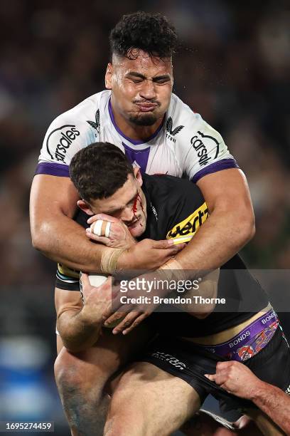 Nathan Cleary of the Panthers is tackled by Eliesa Katoa of the Stormduring the NRL Preliminary Final match between the Penrith Panthers and...