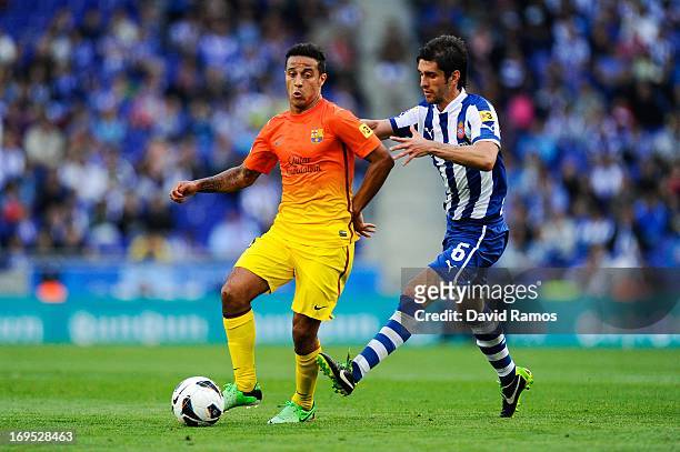 Thiago Alcantara of FC Barcelona duels for the ball with Juan Forlin of RCD Espanyol during the La Liga match between RCD Espanyol and FC Barcelona...