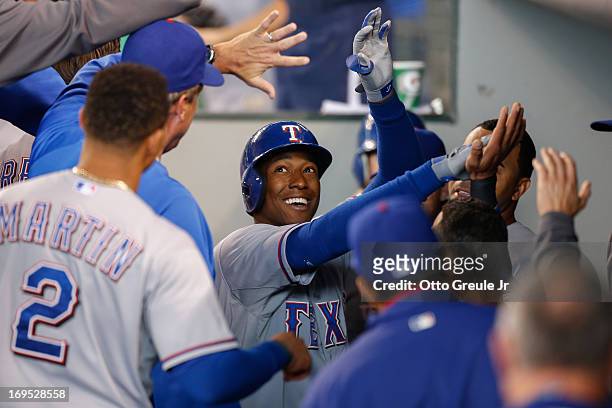 Jurickson Profar of the Texas Rangers is congratulated by teammates after hitting a home run in the first inning against the Seattle Mariners at...