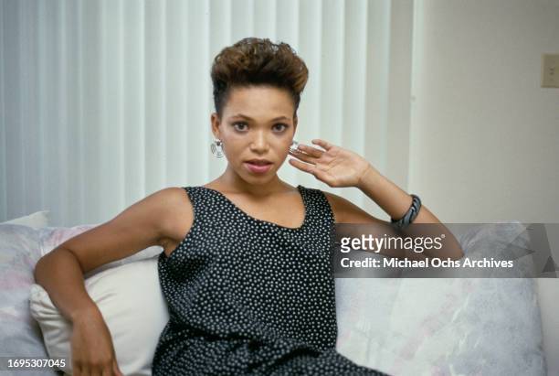 Actress Tisha Campbell poses on a sofa during a casual photoshoot, United States, circa 1988.