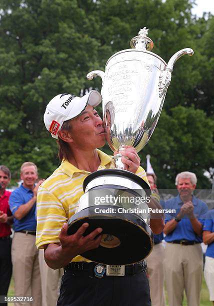 Kohki Idoki of Japan kisses the Alfred S. Bourne Trophy in celebration after winning the Senior PGA Championship presented by KitchenAid at Bellerive...