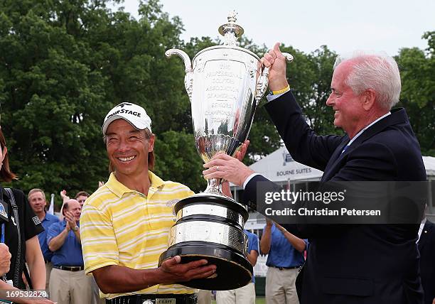 Kohki Idoki of Japan is awarded the Alfred S. Bourne Trophy from PGA of America president Ted Bishop after winning the Senior PGA Championship...