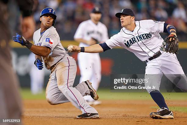 Adrian Beltre of the Texas Rangers attempts to elude the tag of shortstop Brendan Ryan of the Seattle Mariners in the seventh inning at Safeco Field...