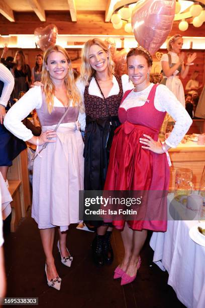 Janina Hell, Sarah Brandner and Felicitas Karrer during the Madlwiesn at Oktoberfest at Schuetzenfestzelt on September 21, 2023 in Munich, Germany.