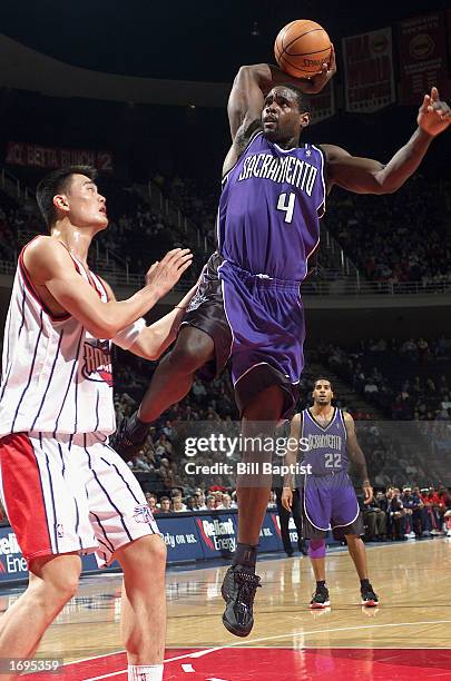 Chris Webber of the Sacramento Kings goes to dunk against Yao Ming of the Houston Rockets during the NBA game at Compaq Center on December 10, 2002...