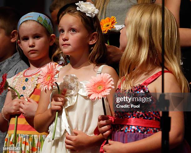 Students Mary Kate Pauley, Madison Perkins, and Isabel White stand on stage during the Oklahoma Strong memorial service held to honor victims of the...