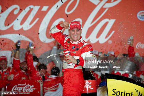 Kevin Harvick, driver of the Budweiser Folds of Honor Chevrolet, celebrates in Victory Lane after winning the NASCAR Sprint Cup Series Coca-Cola 600...