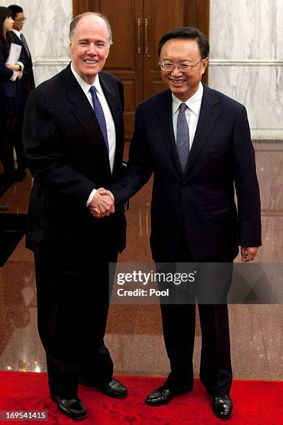 National Security Advisor Tom Donilon and Chinese State Councilor Yang Jiechi shake hands before their meeting at Diaoyutai State Guesthouse on May...