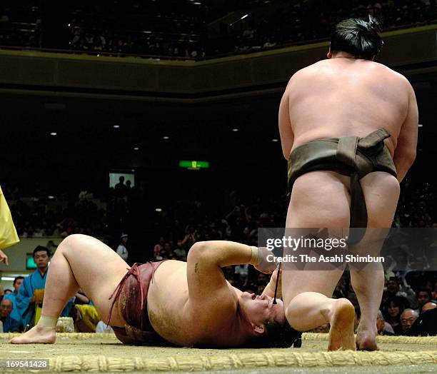 Mongolian Yokozuna, sumo's grand champion Hakuho , whose real name is Mnkhbatyn Davaajargal throws ozeki Kisenosato to win during day fourteen of the...