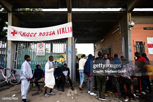 African migrants arriving from the Lampedusa landings wait outside the Red Cross Refugee Center on September 22, 2023 in Turin, Italy. France and...
