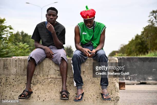 Migrants arriving from the Lampedusa landings wait outside the Red Cross Refugee Center on September 22, 2023 in Turin, Italy. France and Italy will...