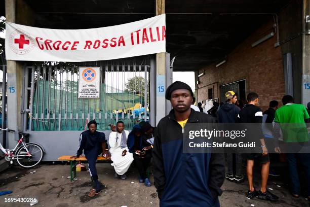 African migrants arriving from the Lampedusa landings wait outside the Red Cross Refugee Center on September 22, 2023 in Turin, Italy. France and...