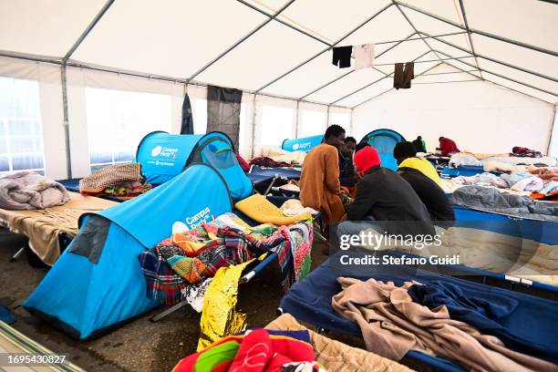 Migrants arriving from the Lampedusa landing are seen outside the Red Cross Refugee Center on September 22, 2023 in Turin, Italy. France and Italy...