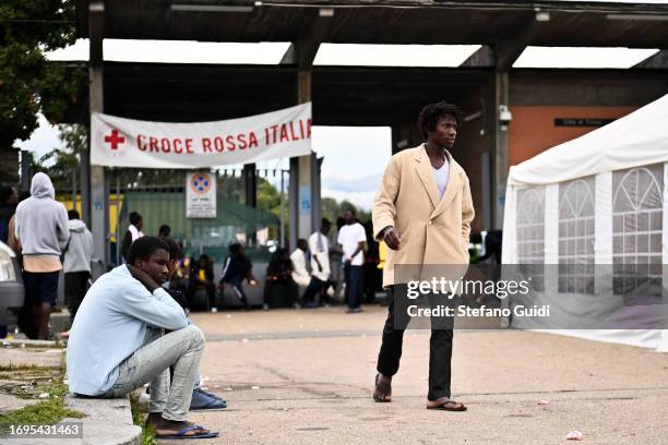 African migrants arriving from the Lampedusa landings wait outside the Red Cross Refugee Center on September 22, 2023 in Turin, Italy. France and...