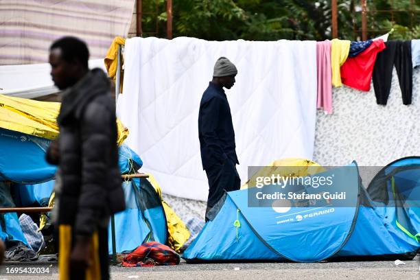 Migrants arriving from the Lampedusa landing are seen in a camp outside the Red Cross Refugee Center on September 22, 2023 in Turin, Italy. France...