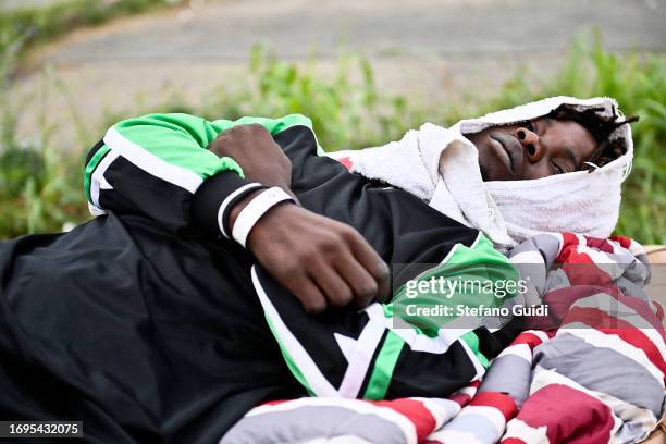 A migrant who has arrived from the Lampedusa landing sleeps outside the Red Cross Refugee Center on September 22, 2023 in Turin, Italy. France and...