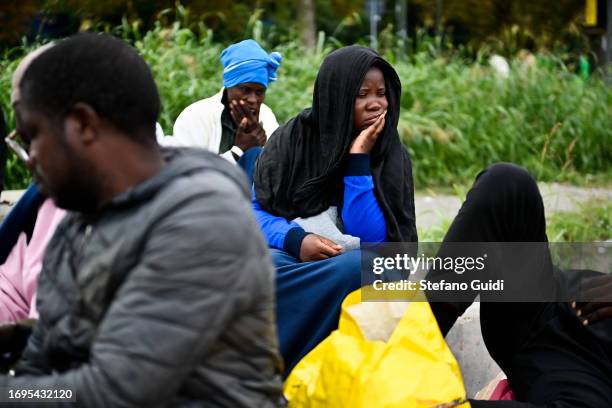 Migrants arriving from the Lampedusa landing are seen outside the Red Cross Refugee Center on September 22, 2023 in Turin, Italy. France and Italy...