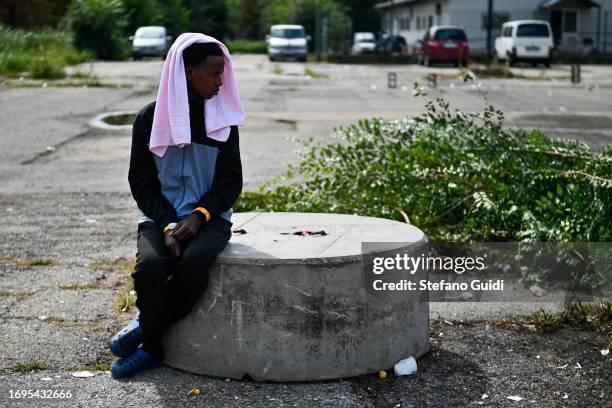 Migrants arriving from the Lampedusa landings wait outside the Red Cross Refugee Center on September 22, 2023 in Turin, Italy. France and Italy will...