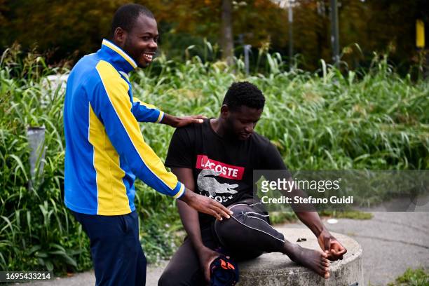 Migrants arriving from the Lampedusa landing are seen outside the Red Cross Refugee Center on September 22, 2023 in Turin, Italy. France and Italy...