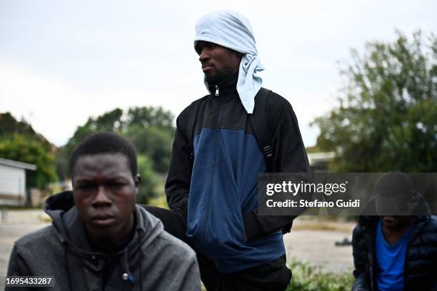 Migrants arriving from the Lampedusa landing are seen outside the Red Cross Refugee Center on September 22, 2023 in Turin, Italy. France and Italy...