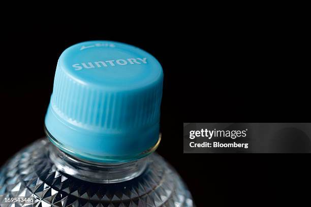 The Suntory Holdings Ltd. Logo is displayed on the bottle cap for Suntory Beverage & Food Ltd.'s flavored water in this arranged photograph taken in...