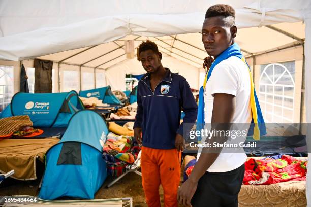 Migrants arriving from the Lampedusa landing are seen in a camp outside the Red Cross Refugee Center on September 22, 2023 in Turin, Italy. France...