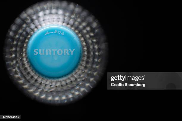 The Suntory Holdings Ltd. Logo is displayed on the bottle cap for Suntory Beverage & Food Ltd.'s flavored water in this arranged photograph taken in...