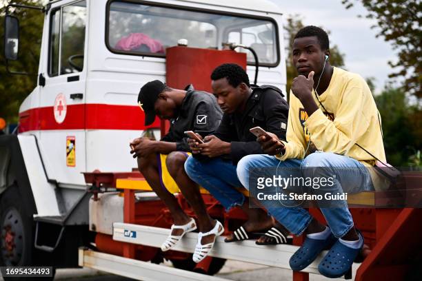 Migrants arriving from the Lampedusa landings wait outside the Red Cross Refugee Center on September 22, 2023 in Turin, Italy. France and Italy will...