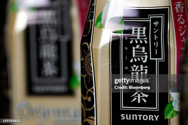 Bottles of Suntory Beverage & Food Ltd.'s Kuro Oolong tea are arranged for a photograph in Soka City, Saitama Prefecture, Japan, on Sunday, May 26,...