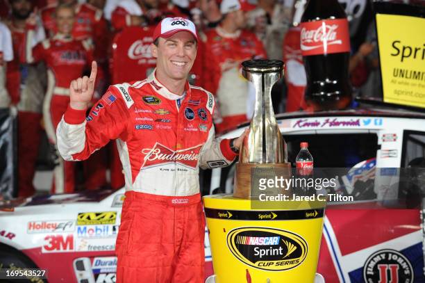 Kevin Harvick, driver of the Budweiser Folds of Honor Chevrolet, poses in Victory Lane after winning the NASCAR Sprint Cup Series Coca-Cola 600 at...