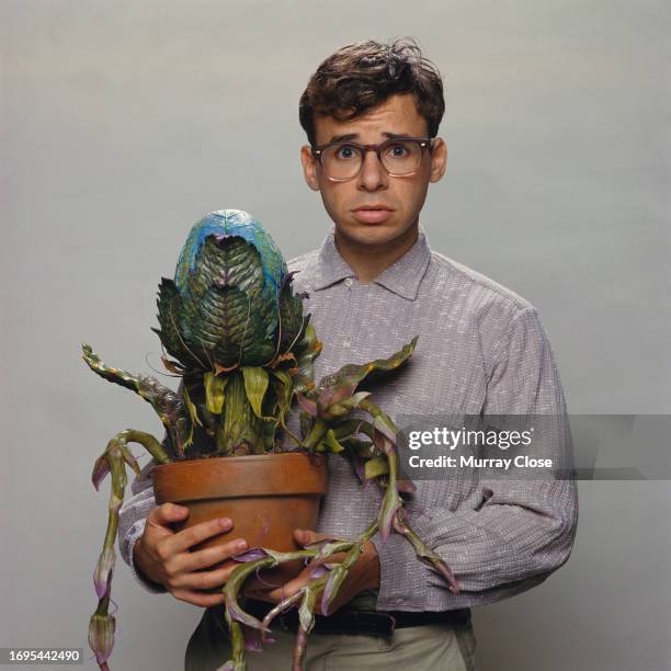 Canadien actor Rick Moranis with the plant Audrey II of the film Little Shop of Horrors, directed by Frank Oz and released in 1986.