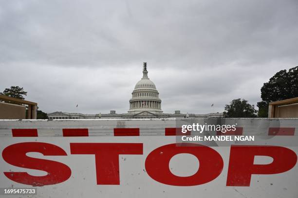 Traffic barrier is seen front of the dome of the US Capitol as a government shut down looms in Washington, DC, on September 28, 2023. The US...