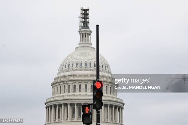 Stoplight is seen in front of the dome of the US Capitol as a government shut down looms in Washington, DC, on September 28, 2023. The US government...