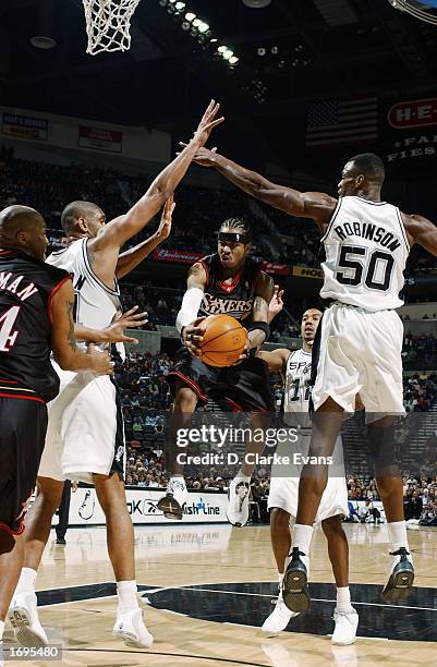 Allen Iverson of the Philadelphia 76ers drives to the basket against Tim Duncan and David Robinson of the San Antonio Spurs during the game on...
